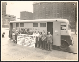 Several people in front of the Mobile x-ray unit bus, undated