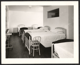Hospital room with newly-made beds, undated