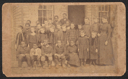 A photograph of what appears to be a desegregated class. An inscription on the back identifies the class as the "1st grade of Miss Lidie Slack". The photograph was taken by A.P. Beecher who had a studio at 315 Market St in Wilmington. There is no date on the image, but it most likely would have been taken between the 1870s, when Beecher first began his studio in Wilmington, and 1911, when Beecher retired.
