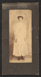 Photograph of a woman wearing a long white dress mounted on a black board. Embossed below the photograph is "A.N. Sanborn 404 Market Street Wilmington, Del.".