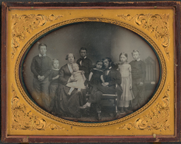 A daguerreotype of Ellwood Garrett and his family, most likely taken in his Wilmington studio at 66 Market St. Based on the children present, probably from 1857.Possible identifications, from left to right:Charles Alfred Garrett (?)Warren Garrett (?)Catharine K. Wollaston Garrett (seated)Agnes (or Emily) GarrettHoward (or Maurice) GarrettEmily (or Agnes) GarrettEllwood Garrett (seated)Elizabeth GarrettMaurice (or Howard) Garrett