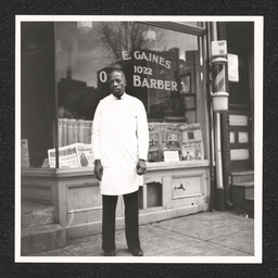 L.E. Gaines outside his barber shop, 1022 Walnut St., December 31, 1939