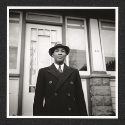 John H. Jackson posing outside his house