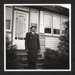 John H. Jackson posing outside his home