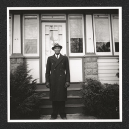 John H. Jackson posing on the steps to his house