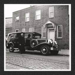 A funeral coach parks outside of the Edward LeMay Gray Funeral Home