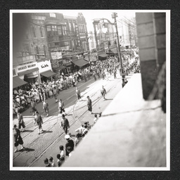 Rooftop view of people participating in a defense parade