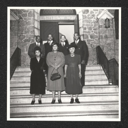 Four men and three women pose on the steps of the Bethel A.M.E Church