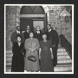 Four men and three women of the Music and Choir Committee pose on the steps of the Bethel A.M.E Church