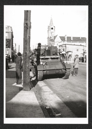 View of a tank driven by men participating in a defense parade