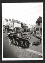 View of a tank driven by men participating in a defense parade