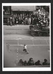 View of a tank driven by men participating in a defense parade