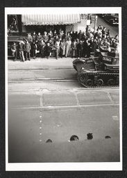 Rooftop view of crowd watching a defense parade