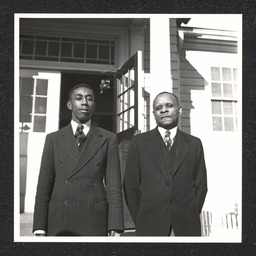 Matthew Coulbourne and Sylvester H. Woolford pose outside the Buttonwood School, New Castle