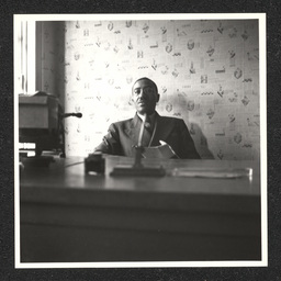 A man sits at a desk