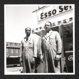 Two men pose outside of the King Street Service Center