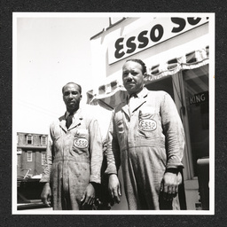 Two men pose outside of the King Street Service Center