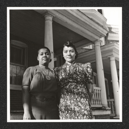 Mrs. Helen C. Moseley and Mrs. Williams pose by a porch