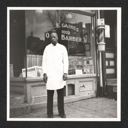 L.E. Gaines posing outside his shop