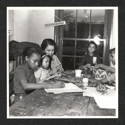 Children in craft class with teacher Sadie Peterson in the Garrett Settlement House. During the Depression, settlement houses such as these provided families with food and shelter and acted as orphanages.