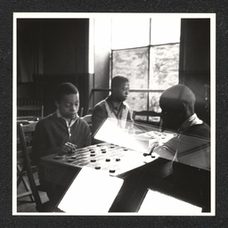 Boys playing checkers at the Garrett Settlement House. During the Depression, settlement houses such as these provided families with food and shelter and acted as orphanages.