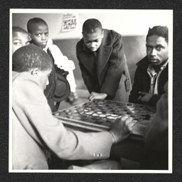 Boys playing checkers in Garrett Settlement House. During the Depression, settlement houses such as these provided families with food and shelter and acted as orphanages.