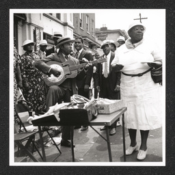 Big August Quarterly 800 block French St., man playing instruments, August 27, 1939