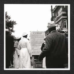 Big August Quarterly, people read a sign, August 27, 1939