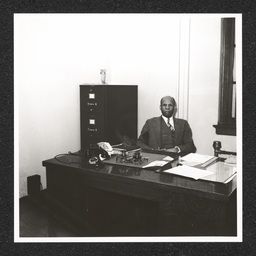 Howard High School 1320 Poplar St., George A. Johnson at desk, 1940