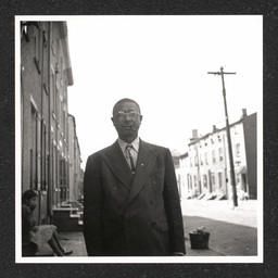 Johnson's Liquor Store 528 Lombard St., Charles Johnson poses outside store with cigar, 1940