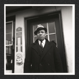  White's Quick Service Station 828 Walnut St., Fletcher G. White posing outside station, February 23, 1938