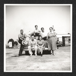 Texaco gas station, people pose on car, 1940