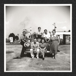 Texaco gas station, people pose on car, 1940