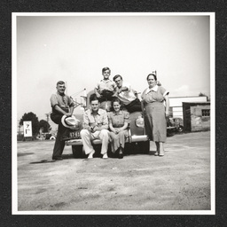 Texaco gas station, people pose on car, 1940