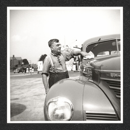 Texaco gas station, owner cleaning windshield, 1940