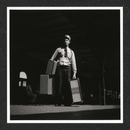 Pennsylvania Railroad Station, porter carries luggage, 1938-40