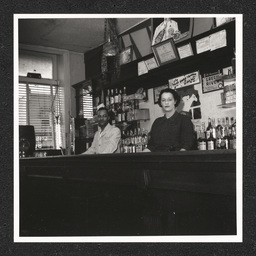 Garlend's Grill Chester PA, man and woman pose behind bar, 1940