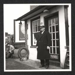 Fletcher G. White, White's Quick Service Station, White at door to his station, February 23, 1938