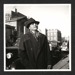 John O. Hopkins, manager National Theater, posing on French St. in front of AUMP Church, December, 1938