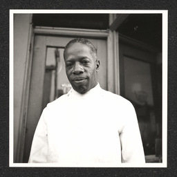 L.E Gaines, L.E. Gaines Barber Shop, close-up of Gaines outside his shop, December 31, 1938