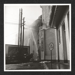 H. Feinberg Furniture Co. 808 King St., street level view of fire being put out, 1940