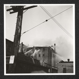 H. Feinberg Furniture Co. 808 King St., rooftop view of fire being put out, 1940