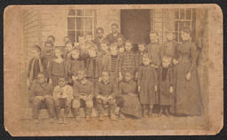 A photograph of what appears to be a desegregated class. An inscription on the back identifies the class as the "1st grade of Miss Lidie Slack". The photograph was taken by A.P. Beecher who had a studio at 315 Market St in Wilmington. There is no date on the image, but it most likely would have been taken between the 1870s, when Beecher first began his studio in Wilmington, and 1911, when Beecher retired.