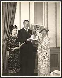 Carl Holboell and Emily Bissell posing with 1907 Christmas seal, October 11, 1939