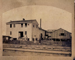 Original building and railroad tracks, 1881.
