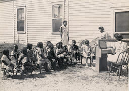 Group of children singing at daycare, 1940.