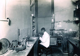 Dentist's office, lab technician, ca. 1900