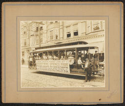 Gelatin silver print of a trolley advertising the grand opening of Brandywine Springs Park, mounted on tan board. An inscription written on the back of the mounting board in pencil reads, "June 21, 1914 Wilmington (Del.) Phila., Traction Co. - Front Seat - William G. Ott - 5 years. - Davis L. Ott, Jr. - 7 years."