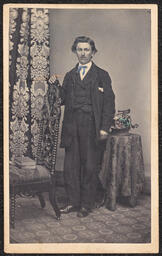 Carte de visite, Man in Suit with Blue Bowtie and Posing Chair, front