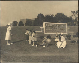 Gelatin silver print, Children and nurses playing in front of sign for Emily P. Bissell Hospital